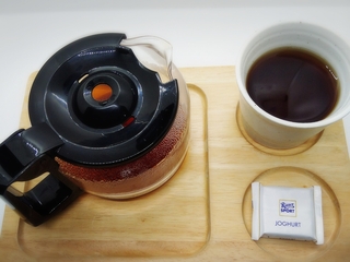 coffee decanter, coffee, and ritter sport chocolate on a wooden tray.jpg