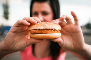 girl-holding-hamburger-in-her-hands-pic