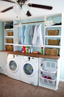 creative-white-wooden-laundry-room-shelving-as-clothes-and-baskets-storage.jpg