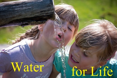 A girl & a boy drinking water.jpg