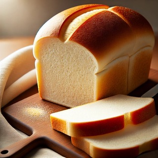 DALLEE 2024-09-18 21.43.26 - A freshly baked loaf of white bread (shokupan), soft and fluffy with a perfectly golden crust. The loaf is sliced to reveal its tender, airy interior.jpg