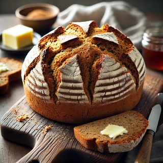 DALLEE 2024-09-23 19.26.35 - A freshly baked loaf of traditional Irish soda bread with a golden-brown crust, marked with the signature cross on top. The loaf is rustic and slightl.jpg