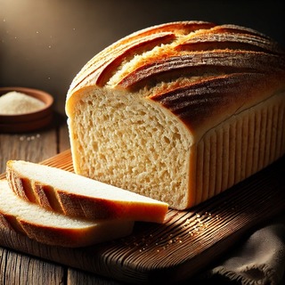 DALLEE 2024-10-21 19.59.06 - A loaf of freshly baked rice bread with a soft, golden-brown crust and a light, moist interior made from rice flour. The bread is sliced to show its f.jpg