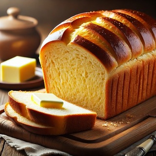 DALLEE 2024-10-24 18.55.14 - A loaf of freshly baked butter bread with a golden, glossy crust and a soft, rich interior. The bread is sliced to reveal its tender, buttery crumb. I.jpg