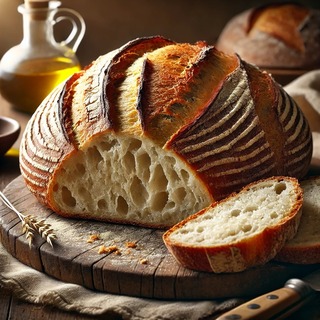 DALLEE 2024-10-27 17.00.48 - A freshly baked Pain Rustique, a French rustic bread with a thick, golden-brown, crackling crust and an open, airy crumb. The bread is displayed on a .jpg