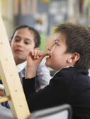 depositphotos_33835487-Elementary-students-sitting-in-classroom.jpg