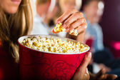 depositphotos_79216310-stock-photo-girl-eating-popcorn-in-cinema.jpg