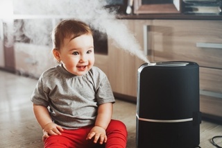 a-little-girl-in-red-pants-is-sitting-next-to-a-humidifier_128841-17.jpg